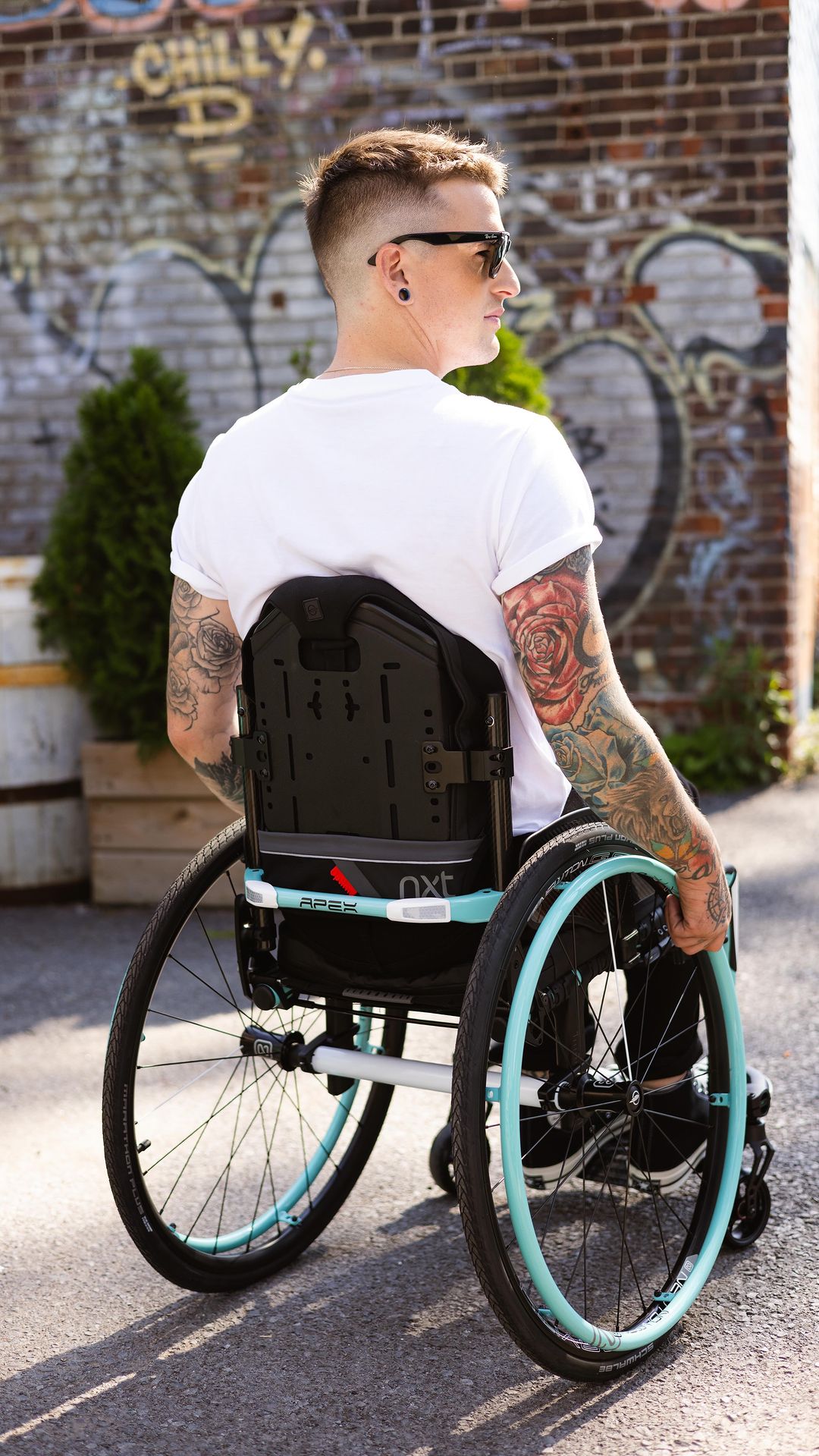 Image of a man utilizing his Newton AirGrip Handrims - Pneumatic wheelchair handrims with air-filled core for improved grip, comfort, and pressure distribution.