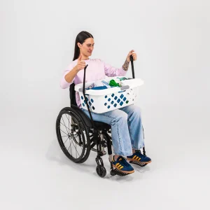 Image of a woman using the LapStacker Flex Manual Rigid Wheelchair Table - Portable, lightweight wheelchair table with adjustable height and tilt, designed for increased independence and productivity.