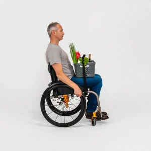 Image of a man using the LapStacker Flex Manual Rigid Wheelchair Table - Portable, lightweight wheelchair table with adjustable height and tilt, designed for increased independence and productivity.