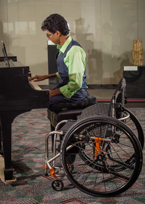 Image of a woman using the ROHO® Hybrid Elite® Dual Compartment Wheelchair Cushion - Pressure relief cushion featuring a combination of air cells and contoured foam base, offering personalized comfort and support for wheelchair users.