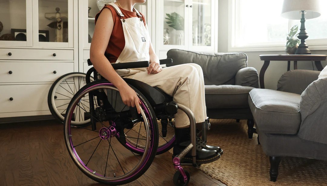 Image of a woman using the Spinergy Handrims - Lightweight, high-performance wheelchair handrims designed for improved propulsion, comfort, and maneuverability.