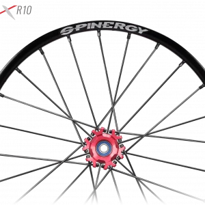 Image of the Spinergy XSLX R10 Wheelchair Wheel - High-performance, lightweight wheelchair wheel featuring a durable X-laced spoke pattern and reinforced axle for increased strength and durability.