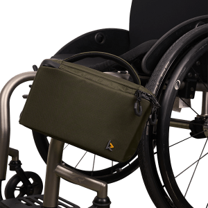 Image of the green Kinetic-Source Rack Pack II Wheelchair Backpack on wheelchair - Securely attaches to the back of a wheelchair backrest, offering convenient storage for essential items during outings.