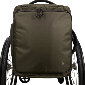 Front view of the green Kinetic Balance Backrest Commuter Backpack - Securely attaches to the backrest of a wheelchair, offering comfortable carrying and organized storage for everyday essentials during commutes or outings.