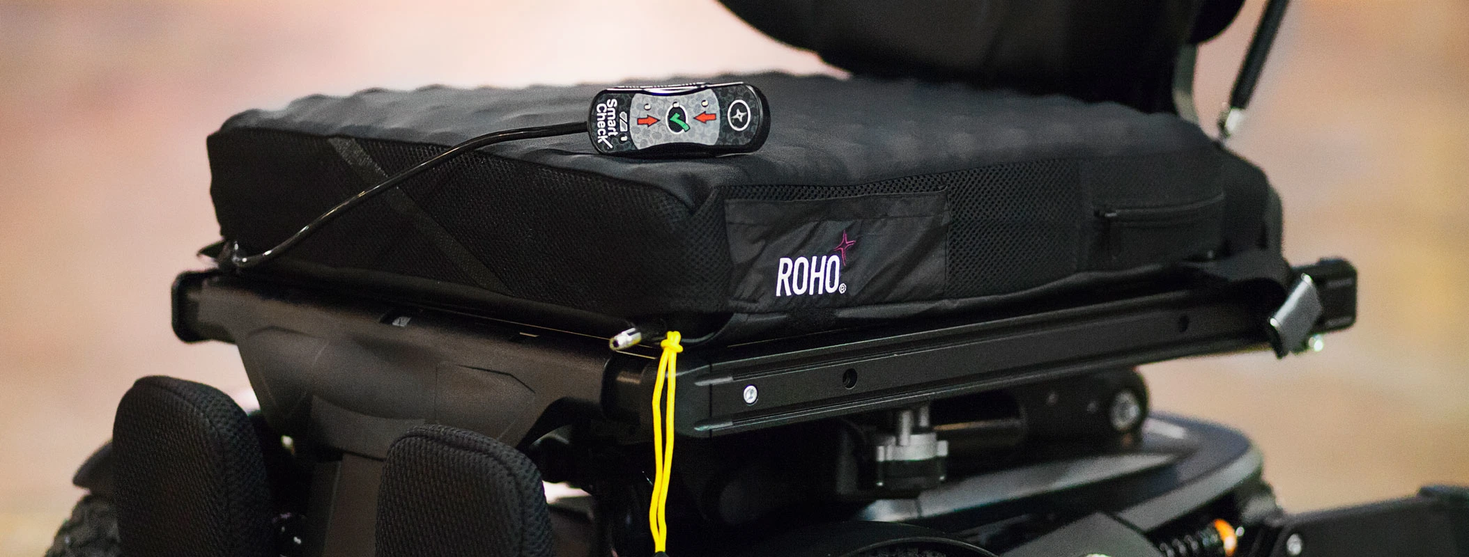 Image of the ROHO High Profile Sensor Ready Cushion with Smart Check on wheelchair - Adjustable air-filled wheelchair cushion with Smart Check technology for pressure sore prevention and skin protection.