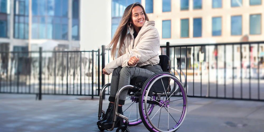 Image of a youthful woman utilizing the Spinergy XLX wheels on a beautiful day.