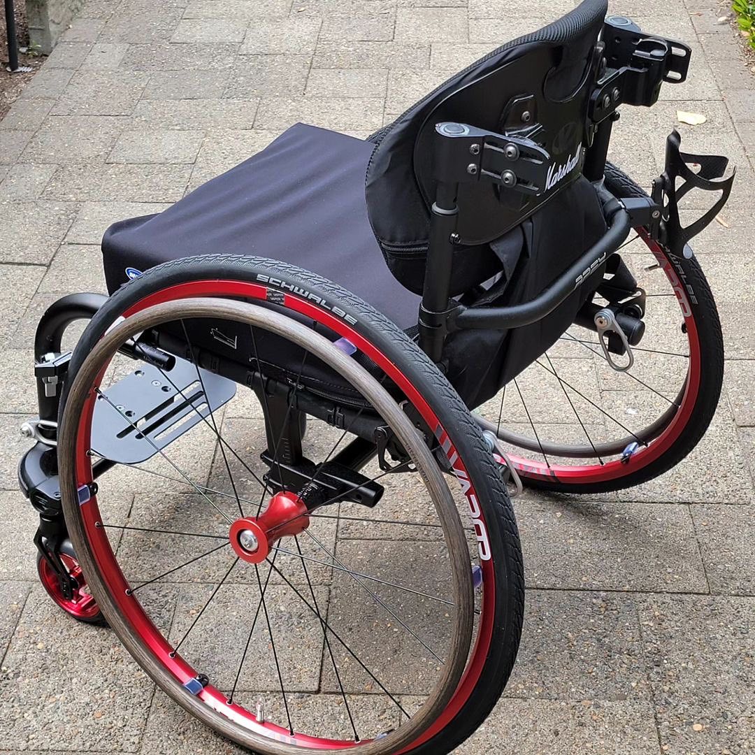 Image of the Vapor X Wheel Set outdoors - Lightweight and responsive wheelchair wheels designed for speed and maneuverability, featuring a sleek aerodynamic design and high-performance tires.