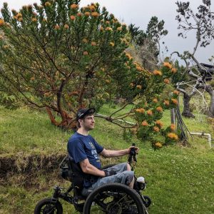 Image of a man in nature enjoying his Sirocco 2.0 Adventurer Power Assist - Compact, maneuverable wheelchair designed for outdoor adventures.