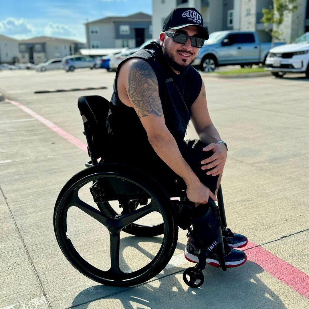 Image of a man using the Carbon Spoke Wheel on a wheelchair - Lightweight, high-performance bicycle wheel with aerodynamically designed carbon fiber spokes for increased stiffness and reduced weight.